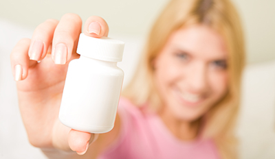 Woman hold a box with vitamins